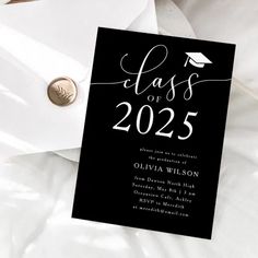 a graduation party card with the word class of 205 on it and a coin laying next to it