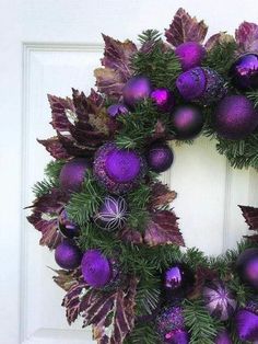 a wreath with purple and green ornaments on it