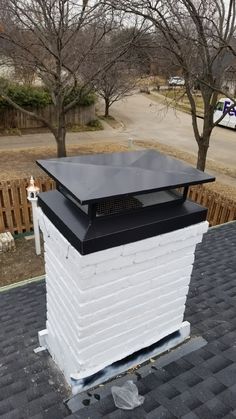 a black and white chimney on top of a roof