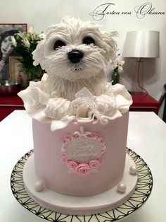 a white dog is sitting in a pink cake