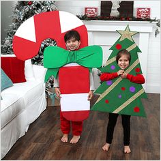 two children in christmas costumes standing next to each other