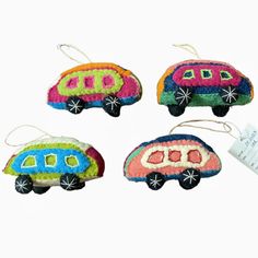 three ornaments made to look like cars are hanging from strings on a white background with a price tag in the foreground