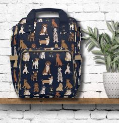 a dog print backpack sitting on top of a shelf next to a potted plant