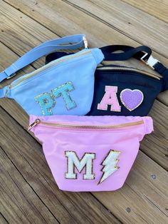 "These custom fanny packs are the perfect bag for your weekend hikes or your girls day out. They also make the perfect gift for any of your besties! Toss your sunnies and wallet in the zipper compartment and sling this across your back for a chic outfit accessory Details: - Nylon Fanny Pack - Easy clean lining; spot clean exterior - 13\" x 7\" - Patches are permanently adhered, not sewn. - Patch Color Options: White, Mint, Light Pink, Light Blue, Lavender - Symbol Options: pink lightning bolt, w Trendy Belt Bag With Zipper Pocket For Outdoor Activities, Trendy Belt Bag With Zipper Pocket For Outdoor, Trendy Everyday Bag With Letter Patch, Trendy Customizable Bags, Pink Lightning Bolt, Summer Bags Beach, Pink Lightning, Preppy Gifts, Pink Patch