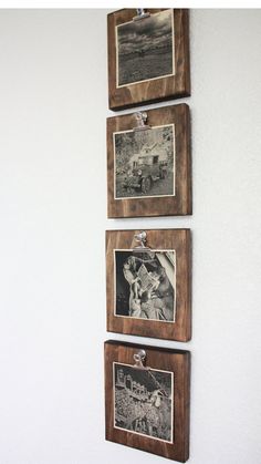 three wooden frames hanging on the wall with pictures attached to them and pinned to each other