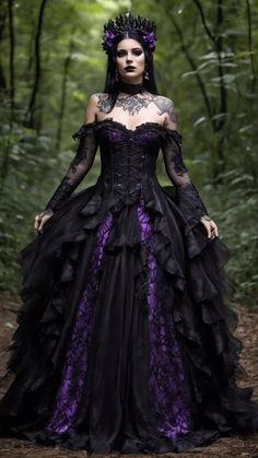 a woman wearing a black and purple dress in the woods