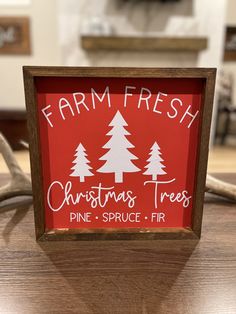 a sign that says farm fresh christmas trees pine, spruce and fir on the table