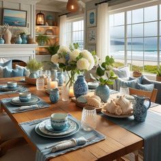 a dining room table set with blue and white dishes, plates and vases on it