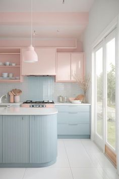 a kitchen with pink and blue cabinets, white countertops and an island in the middle