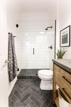 a white toilet sitting next to a walk in shower