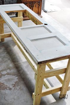 an unfinished table is being built in a shop