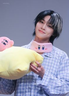 a man holding a stuffed animal and banana