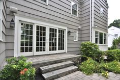 an outside view of a house with steps leading up to the front door and windows