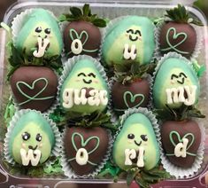 chocolate covered strawberries are arranged in the shape of hearts and letters with faces on them