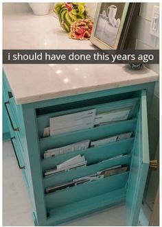 a blue cabinet with many files in it and a framed photo on the counter top