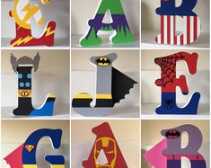 the letters are made out of paper and decorated with superheros, spiderman, batgirl, captain america, batman