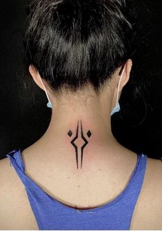 a woman's neck with a tattoo on the back of her neck and an arrow