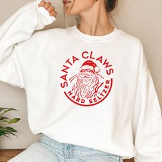 Santa Claws | Bad Santa | Christmas Holiday Sweater | Crewneck Sweatshirt | White Claws & Drunk Santa | DETAILS * Unisex Heavy Blend™ Crewneck Sweatshirt * Soft & medium-heavy fabric * 50% cotton 50% polyester * Design is printed using DTG technology which uses high-quality water-based inks that are printed directly into the fabric. SHIPPING * Multiple orders may ship separately.  * Shipping takes 3-5 days to arrive in USA * During the holidays there may be delays with the postal services SIZING * Runs true-to-size for unisex crewneck * If you would like a more oversized look, we recommend sizing up 1 or 2 sizes. * A size charts in provided in the listing. Please always check your size before placing your order. COLOR/IMAGE DISCLAIMER *Mock ups are used for demonstration purposes only, and Drunk Santa, White Claws, Christmas Sweater For Women, Santa Claws, Cute Christmas Sweater, Bad Santa, Christmas Sweaters For Women, Funny Holiday, Xmas Sweater