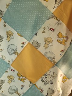 a patchwork quilt with winnie the pooh characters on it