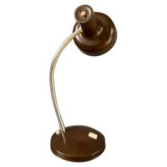 a brown desk lamp on a white background