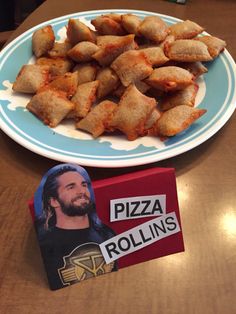 a plate with pizza rolls on it next to a box of rolling doughnuts