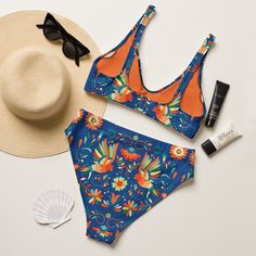 Inspired by the rich culture and intricate designs of Mexico's Otomi artwork, our Recycled High-Waisted Bikini features a stunning print against a deep blue backdrop. Dive into style and sustainability with this eco-friendly swimwear! Perfect for lounging by the pool or catching waves at the beach, this bikini combines fashion with environmental consciousness. Get ready to make a splash while paying homage to Mexican artistry! It’s too easy to fall in love with this bikini set. Removable pads and its double-layer make it comfy to wear all day by the pool or at the beach.This bikini is destined to become the only swimsuit you'll want to reach for in your drawer! The bottoms are high-waisted, and the top has removable pads. Both come with a tear-away care label. Made of recycled materials (l Multicolor High Waist Floral Swimwear, Multicolor High Waist Printed Swimwear, Multicolor High Waist Floral Print Swimwear, High Waist Multicolor Printed Swimwear, Multicolor Printed High Waist Swimwear, Multicolor Printed High-waist Swimwear, Blue Swimwear With Vibrant Print, Blue Vibrant Print Swimwear, Vibrant Blue Printed Swimwear