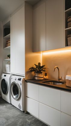 a washer and dryer sitting in a kitchen next to each other on top of a counter