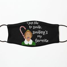 a black face mask with an image of a woman holding a candy cane in her mouth