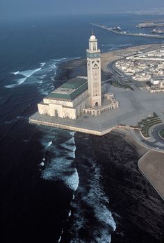 an aerial view of a large building with a clock tower on it's side