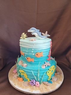 there is a blue cake with sea animals on it