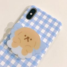 a cell phone case with a cartoon sheep on the front and blue gingham checkered background