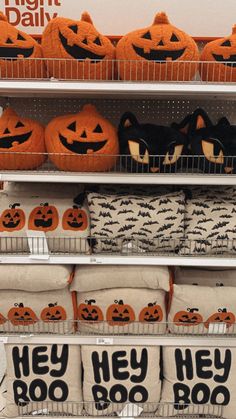 pumpkins and pillows are on display in a store