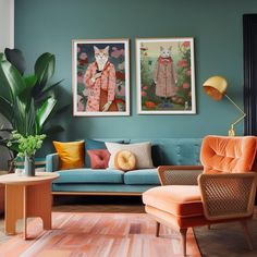 a living room filled with furniture and paintings on the wall next to a blue couch