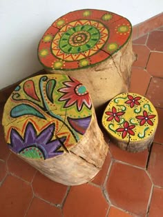 three wooden stools sitting on top of a tiled floor