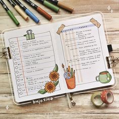 an open notebook with writing and markers on it