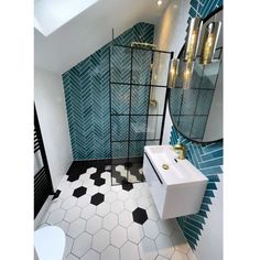 a bathroom with blue and white tiles on the walls, flooring and a shower