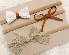 two wedding garters with bows and lace on them sitting on a piece of paper