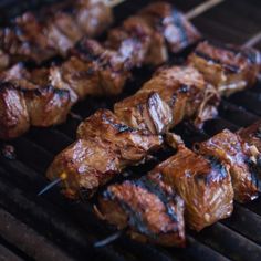 some meat is being cooked on a grill