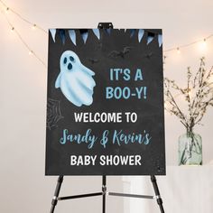 a welcome sign for a baby shower with ghost on it's face and the words, it's a boo - y welcome to sandy & kernis