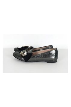 The leather of these flats has a unique crackled look. A bold rhinestone and ribbon design adorns the front. These luxe flats have all of the shimmer and glam you need. Size 6.5 (EU 36.5) Leather upper, lining & sole Made in Italy Rounded toe Crackled look to leather Rhinestone detail on front w/ ribbon Mirrored design on heel Light scuffs on toe Some outsole wear Outsole length 10" Glamorous Closed Toe Party Flats, Glitter Round Toe Flats For Party, Glitter Flats With Round Toe For Party, Glitter Party Flats With Round Toe, Party Loafers With Almond Toe Slip-on, Chic Party Ballet Flats With Closed Toe, Chic Closed Toe Ballet Flats For Party, Party Slip-on Loafers With Round Toe, Slip-on Round Toe Loafers For Party