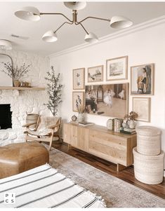 a living room filled with furniture and pictures on the wall