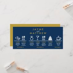 a blue and gold business card with the names of different things in it on top of a marble surface