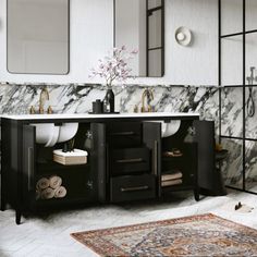 a bathroom with marble counter tops and black cabinetry, along with a rug on the floor