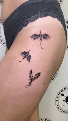 a woman's thigh with two bats on it