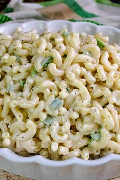 a bowl filled with macaroni and cheese on top of a table