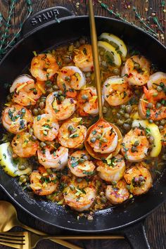 a skillet filled with cooked shrimp and vegetables