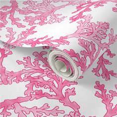 a pink and white wallpaper with coral print on the bottom, along with a roll of tape