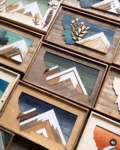 many different frames are stacked on top of each other with leaves and pine cones in them