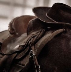 a close up of a horse's saddle with a hat on top of it