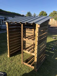 a small wooden structure sitting in the grass